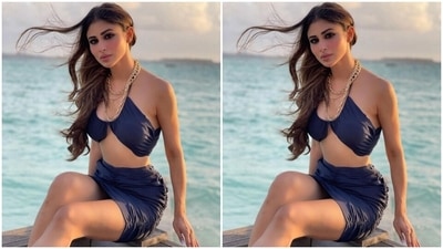The first photo shows Mouni in a dark blue sleeveless bralette featuring a halter neckline, gathered details and an inverted hem. She teamed it with a matching mini skirt with similar ruched up elements. She wore the ensemble with layered gold chunky chains, open windblown tresses, smoky eye shadow, kohled eyes, and sunkissed skin. (Instagram/@imouniroy) The first photo shows Mouni in a dark blue sleeveless bralette featuring a halter neckline, gathered details and an inverted hem. She teamed it with a matching mini skirt with similar ruched up elements. She wore the ensemble with layered gold chunky chains, open windblown tresses, smoky eye shadow, kohled eyes, and sunkissed skin. (Instagram/@imouniroy)