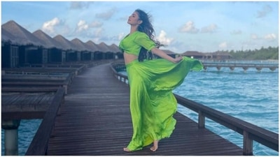 This photo shows Mouni enjoying the wind and the stunning scenery of Maldives, dressed in an all-green ensemble. The star posed for the click while standing on a wooden dock by the clear blue sea, featuring a gorgeous sky in the backdrop. (Instagram/@imouniroy) This photo shows Mouni enjoying the wind and the stunning scenery of Maldives, dressed in an all-green ensemble. The star posed for the click while standing on a wooden dock by the clear blue sea, featuring a gorgeous sky in the backdrop. (Instagram/@imouniroy)