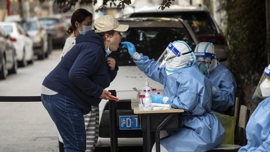 Residents have swab samples collected in a round of Covid-19 testing during a lockdown in Shanghai, China.(Bloomberg)