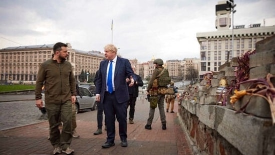 &nbsp;Ukrainian President Volodymyr Zelenskyy, left, and Britain's Prime Minister Boris Johnson, center, talk next to a memorial for Heavenly Hundred, near Independence Square in Kyiv, Ukraine.