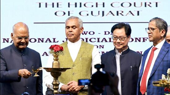 President Ram Nath Kovind lights the lamp during the inauguration of a two-day National Judicial Conference on Mediation and Information Technology organised by the Gujarat High Court, as Chief Justice of India (CJI) Justice NV Ramana, Union Minister of Law and Justice Kiren Rijiju and Gujarat Governor Acharya Devvrat look on at Ekta Nagar, in Narmada on Saturday. (ANI PHOTO.)