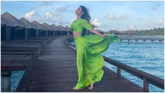 This photo shows Mouni enjoying the wind and the stunning scenery of Maldives, dressed in an all-green ensemble. The star posed for the click while standing on a wooden dock by the clear blue sea, featuring a gorgeous sky in the backdrop.(Instagram/@imouniroy)