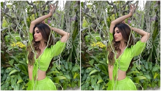 Mouni's outfit features a green blouse with front knot detail, a plunging V neckline, half sleeves with gathered cuffs, and a midriff-baring hem. The star wore the silk satin top with a long and flowy skirt.(Instagram/@imouniroy)