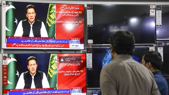Televisions broadcast live footage of Imran Khan, Pakistan's prime minister, in Rawalpindi, Pakistan, on Friday, April 8, 2022. (Photographer: Asad Zaidi/Bloomberg)