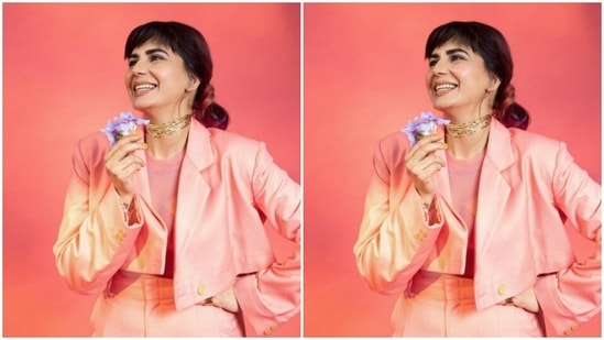 Kirti teamed a pink top with a pink cropped blazer and a pair of high-waisted pink trousers as she posed for the picture holding a flower.(Instagram/@iamkirtikulhari)