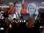 A screen shows French President Emmanuel Macron and centrist candidate for reelection and far-right candidate Marine Le Pen at her election day headquarters, in Paris. A screen shows French President Emmanuel Macron and centrist candidate for reelection and far-right candidate Marine Le Pen at her election day headquarters, in Paris.
