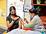 A woman receives a booster jab at a centre in Tilak Nagar. A woman receives a booster jab at a centre in Tilak Nagar.