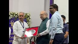 Union home minister Amit Shah presenting the active participation award to Haryana Dairy Development Cooperative Federation chairperson Randhir Singh and managing director A Sreenivas in Gandhinagar. (HT Photo)