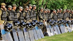 Paramilitary soldiers stand guard on a road leading to Parliament in Islamabad on Saturday.&nbsp;