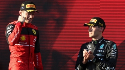 Ferrari driver Charles Leclerc of Monaco celebrates after winning the Australian Formula One Grand Prix as third placed Mercedes driver George Russell, right, of Britain watches in Melbourne, Australia. (AP) Ferrari driver Charles Leclerc of Monaco celebrates after winning the Australian Formula One Grand Prix as third placed Mercedes driver George Russell, right, of Britain watches in Melbourne, Australia. (AP)