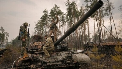 A Ukrainian serviceman takes a selfie standing on a destroyed Russian tank after Ukrainian forces overran a Russian position outside Kyiv. (AP) A Ukrainian serviceman takes a selfie standing on a destroyed Russian tank after Ukrainian forces overran a Russian position outside Kyiv. (AP)