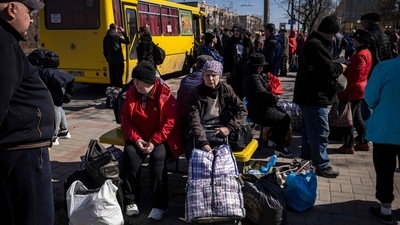 People wait for a bus to go in a train station in Severodonetsk, eastern Ukraine as they flee the city in the Donbas region. The United Nations estimates that 7.1 million people have been displaced within the country, according to figures published by the IOM on April 5. (Photo by FADEL SENNA / AFP) People wait for a bus to go in a train station in Severodonetsk, eastern Ukraine as they flee the city in the Donbas region. The United Nations estimates that 7.1 million people have been displaced within the country, according to figures published by the IOM on April 5. (Photo by FADEL SENNA / AFP)