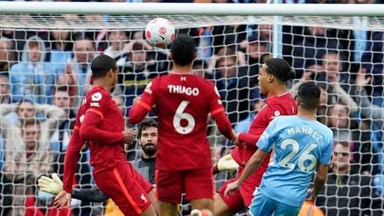 Manchester City's Riyad Mahrez, right, kicks the ball during the English Premier League soccer match between Manchester City and Liverpool, at the Etihad stadium in Manchester.(AP)