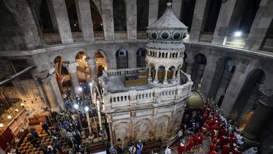 Roman Catholic clergy carry palm branches as they circle the aedicule during the Palm Sunday procession at the Church of the Holy Sepulchre in Jerusalem's Old City. The ceremony is a landmark in the Roman Catholic calendar, marking the triumphant return of Christ to Jerusalem the week before his death, when a cheering crowd greeted him waving palm leaves. Palm Sunday marks the start of the most solemn week in the Christian calendar. (Photo by AHMAD GHARABLI / AFP) Roman Catholic clergy carry palm branches as they circle the aedicule during the Palm Sunday procession at the Church of the Holy Sepulchre in Jerusalem's Old City. The ceremony is a landmark in the Roman Catholic calendar, marking the triumphant return of Christ to Jerusalem the week before his death, when a cheering crowd greeted him waving palm leaves. Palm Sunday marks the start of the most solemn week in the Christian calendar. (Photo by AHMAD GHARABLI / AFP)