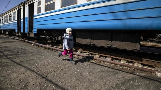 A child runs in the train station near the city of Severodonetsk, eastern Ukraine, as residents flee the city in the Donbass region on Thursday.(Photo by FADEL SENNA / AFP)