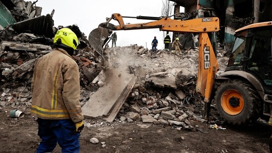 Rescuers work among remains of residential building destroyed by Russian shelling,as they search for bodies, amid Russia's Invasion of Ukraine is seen in Borodyanka, Kyiv region.(Reuters)