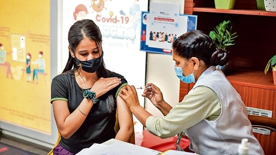 A woman receives a booster jab at a centre in Tilak Nagar.