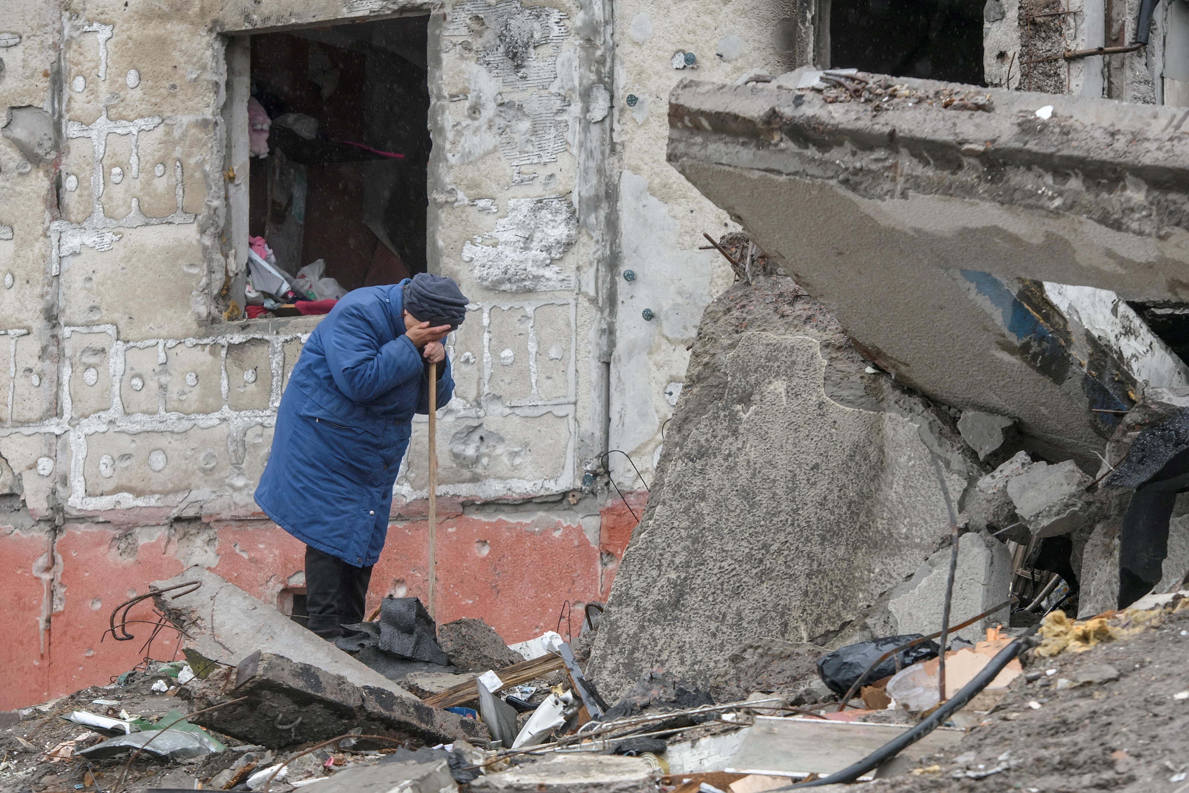 A woman cries as she tries to find a body of her son among debris of a residential building destroyed during Russia’s invasion in the town of Borodianka, Kyiv, Ukraine April 9.&nbsp; (Reuters)