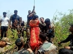 Paramilitary personnel rescue a woman during an operation carried out by Indo-Tibetan Border Police (ITBP) and National Disaster Response Force (NDRF) personnel, where the ropeway trolley accident took place, near Trikut, in Deoghar on Monday. (ANI Photo) Paramilitary personnel rescue a woman during an operation carried out by Indo-Tibetan Border Police (ITBP) and National Disaster Response Force (NDRF) personnel, where the ropeway trolley accident took place, near Trikut, in Deoghar on Monday. (ANI Photo)