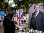 Members of the Anglo-Iranian community and supporters of the National Council of Resistance of Iran (NCRI) attend a memorial service to pay tribute to slain British lawmaker David Amess in Parliament Square in front of the Houses of Parliament in central London. Members of the Anglo-Iranian community and supporters of the National Council of Resistance of Iran (NCRI) attend a memorial service to pay tribute to slain British lawmaker David Amess in Parliament Square in front of the Houses of Parliament in central London.