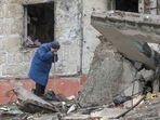 A woman cries as she tries to find a body of her son among debris of a residential building destroyed during Russia’s invasion in the town of Borodianka, Kyiv, Ukraine April 9.&nbsp;