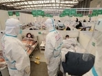 Medical workers conduct ward rounds at Shanghai New International Exhibition Hall, which has been turned into a makeshift hospital for Covid-19 patients, in Shanghai, China.&nbsp;