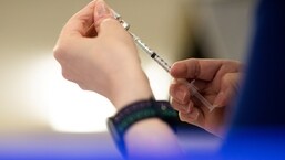 A nurse fills up syringes with the coronavirus disease (COVID-19) vaccine.