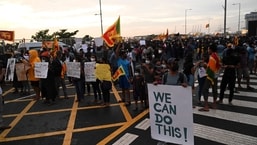 Demonstrators hold placards as they take part in a protest against the economic crisis at the entrance of the president's office in Colombo. Severe shortages of food and fuel, alongside lengthy electricity blackouts, have led to weeks of widespread anti-government demonstrations with calls for President Gotabaya Rajapaksa to resign.