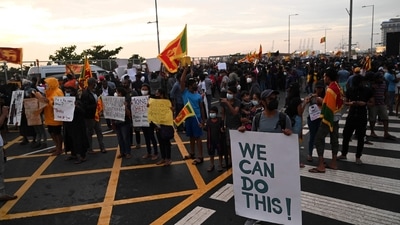 Demonstrators hold placards as they take part in a protest against the economic crisis at the entrance of the president's office in Colombo. Severe shortages of food and fuel, alongside lengthy electricity blackouts, have led to weeks of widespread anti-government demonstrations with calls for President Gotabaya Rajapaksa to resign. (AFP) Demonstrators hold placards as they take part in a protest against the economic crisis at the entrance of the president's office in Colombo. Severe shortages of food and fuel, alongside lengthy electricity blackouts, have led to weeks of widespread anti-government demonstrations with calls for President Gotabaya Rajapaksa to resign. (AFP)