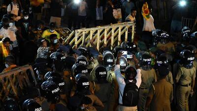 Police blocking protesters during a rally against rise of prices and shortage of fuel at the Sri Lanka prime minister' residence. (AFP)