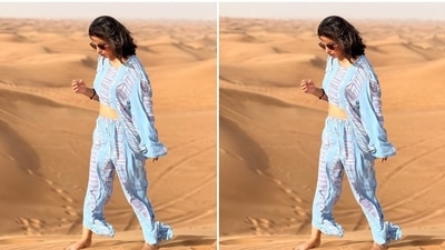 The quirky pattern on the top and the pants in blue, grey and white shades add a quirky touch to Hina's look. She posed barefoot in the dunes and showed off her ensemble. In the end, Hina chose tinted sunglasses, open tresses, and minimal make-up to round off the look. (Instagram/@realhinakhan) The quirky pattern on the top and the pants in blue, grey and white shades add a quirky touch to Hina's look. She posed barefoot in the dunes and showed off her ensemble. In the end, Hina chose tinted sunglasses, open tresses, and minimal make-up to round off the look. (Instagram/@realhinakhan)