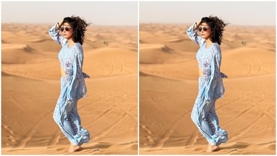 Hina's ensemble features a crop top with long sleeves, a round neckline, and an asymmetric hem - a midriff-baring front and long flowy back. She teamed it with matching printed pants that have a flared hem. (Instagram/@realhinakhan) Hina's ensemble features a crop top with long sleeves, a round neckline, and an asymmetric hem - a midriff-baring front and long flowy back. She teamed it with matching printed pants that have a flared hem. (Instagram/@realhinakhan)