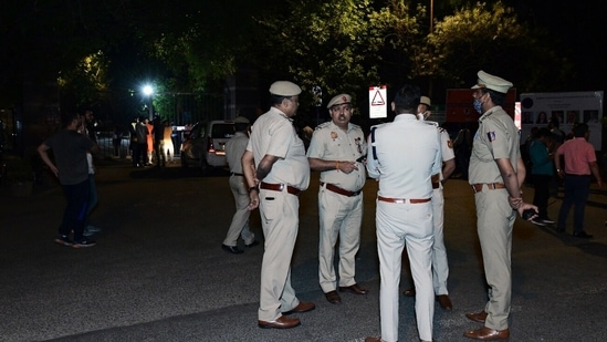 New Delhi, Apr 10 (ANI): Police personnel stand guard at JNU entrance after a scuffle broke out between two groups over allegedly eating non-vegetarian food, in New Delhi on Sunday. (ANI Photo) 