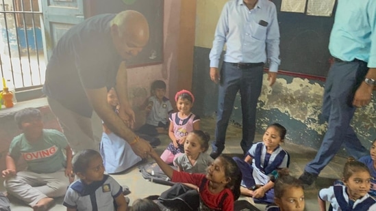 Delhi deputy chief minister, who also holds the education portfolio in the union territory government, interacts with teachers and students during his visit to a school in Gujarat's Bhavnagar. (Twitter/Manish Sisodia)