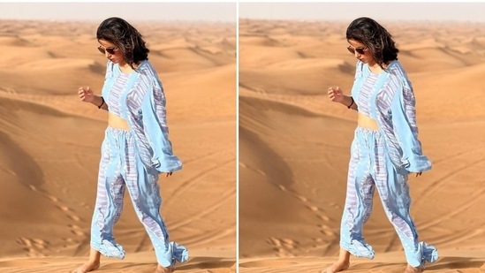 The quirky pattern on the top and the pants in blue, grey and white shades add a quirky touch to Hina's look. She posed barefoot in the dunes and showed off her ensemble. In the end, Hina chose tinted sunglasses, open tresses, and minimal make-up to round off the look.(Instagram/@realhinakhan)