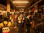 People wait for the subway train after a shooting at a subway station in the Brooklyn borough of New York City, New York, U.S.