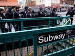 Members of the New York Police Department patrol the streets after at least 13 people were injured during a rush-hour shooting at a subway station in the New York borough of Brooklyn.