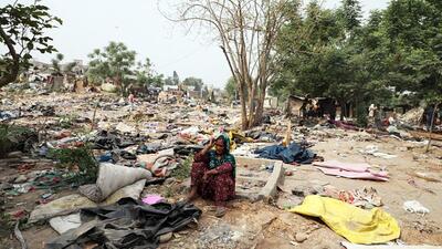A woman sits after her makeshift house is demolished in Jammu on Tuesday. (ANI)
