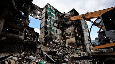 A rescuer walks during a search operation for bodies under the rubble of a building destroyed by Russian shelling, amid Russia's Invasion of Ukraine, in Borodyanka, Kyiv region, Ukraine. (Reuters)