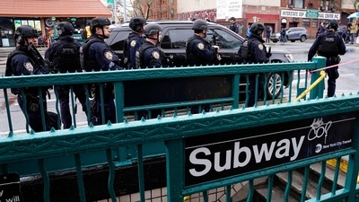 Members of the New York Police Department patrol the streets after at least 13 people were injured during a rush-hour shooting at a subway station in the New York borough of Brooklyn. (AFP)
