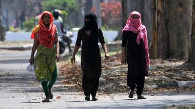 Women protecting themselves with dupattas on a hot Tuesday afternoon in Sector 25, Chandigarh. Cool winds on Wednesday will help lower the temperature, according to the IMD. (Ravi Kumar/HT)