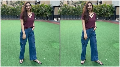 Disha chose a trendy top and flared denim jeans for the garden photoshoot. It comes in a wine-coloured shade and features a plunging V neckline, criss-cross straps on the front, half sleeves, and a figure-skimming silhouette that hugged Disha's curves. (Instagram/@dishaparmar) Disha chose a trendy top and flared denim jeans for the garden photoshoot. It comes in a wine-coloured shade and features a plunging V neckline, criss-cross straps on the front, half sleeves, and a figure-skimming silhouette that hugged Disha's curves. (Instagram/@dishaparmar)