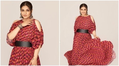 Raveena Tandon made jaws drop as she posed in this printed cold shoulders flared dress paired with a huge black belt. (Instagram/@officialraveenatandon)