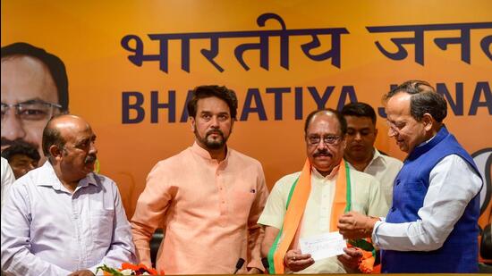 Union minister Anurag Thakur and BJP national general secretary Arun Singh had on Monday inducted former AAP leader DK Tyagi into the party fold in New Delhi. Former AAP Himachal Pradesh president Anoop Kesari is also seen. (PTI)
