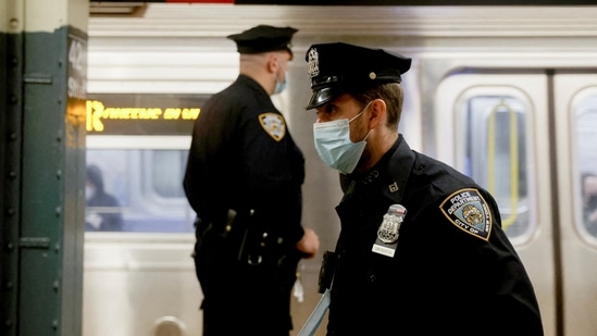 Police and security officers patrol Manhattan subways after a shooting at a subway station in the Brooklyn borough of New York City, New York, US, April 12, 2022. (REUTERS/Jeenah Moon)