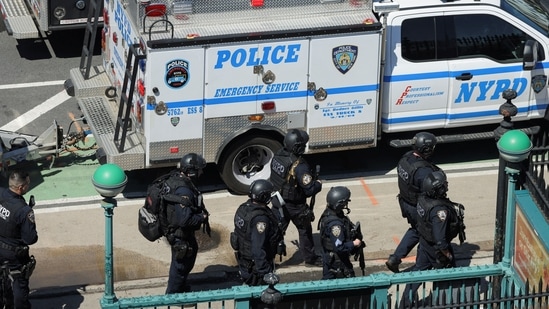 New York City Police Department (NYPD) officers leave a subway station, the scene of a shooting, in the Brooklyn borough on April 12, 2022.&nbsp;