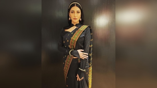 Shruti Haasan wore a black traditional pat silk saree that Assam is famous for and teamed it with a cut-out full-sleeved blouse.(Instagram/@shrutzhaasan)
