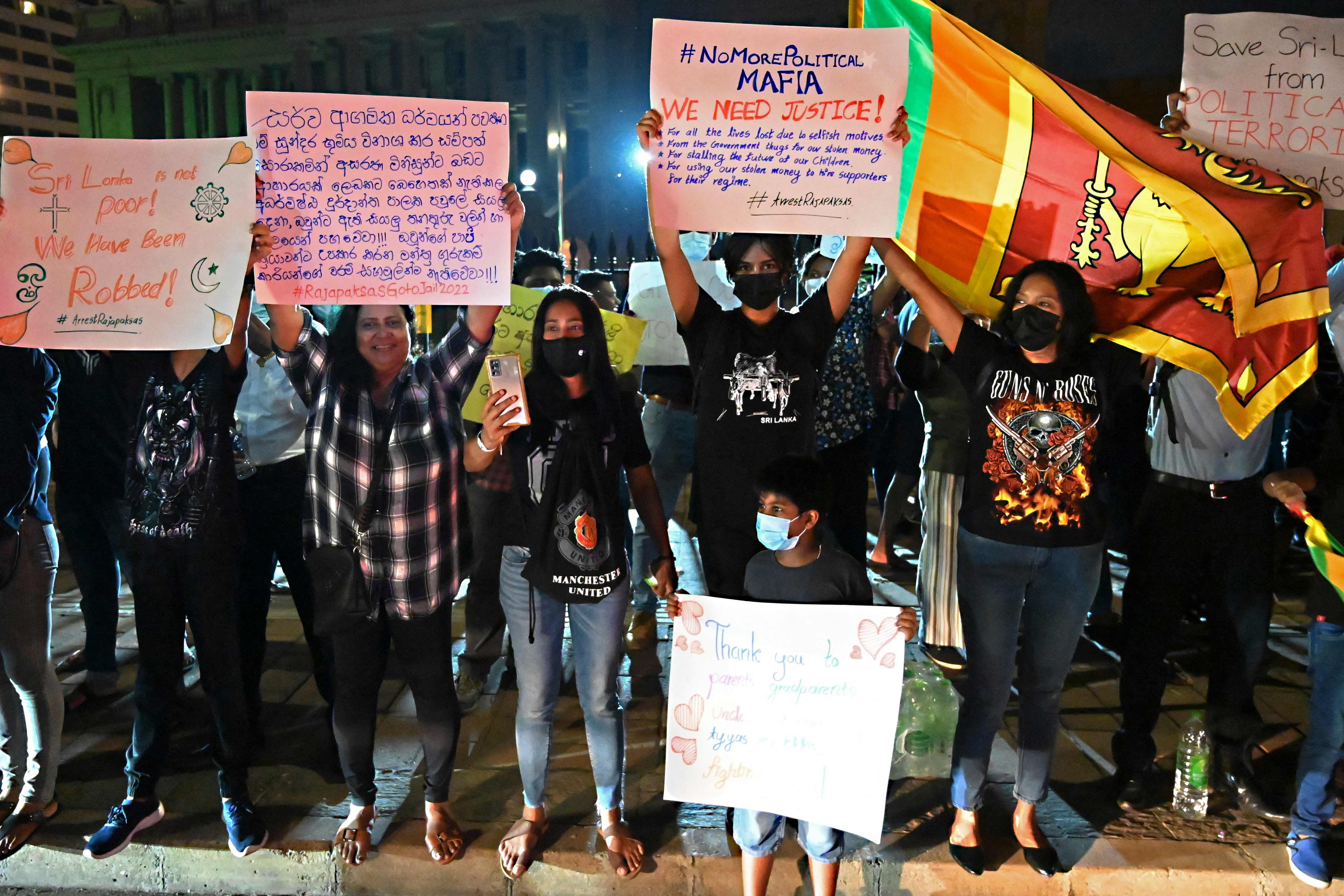 Protestors take part in a demonstration against the economic crisis at the entrance of the president's office in Colombo on April 11, 2022. (AFP) Protestors take part in a demonstration against the economic crisis at the entrance of the president's office in Colombo on April 11, 2022. (AFP)
