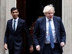 FILE PHOTO: British Prime Minister Boris Johnson and Chancellor of the Exchequer Rishi Sunak walk out of Downing Street.