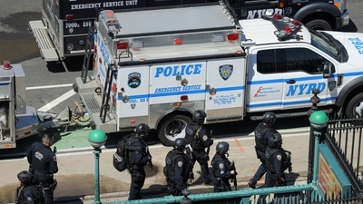 Brooklyn Shooting: New York City Police Department (NYPD) officers leave a subway station, the scene of a shooting, in the Brooklyn borough.&nbsp; (REUTERS)